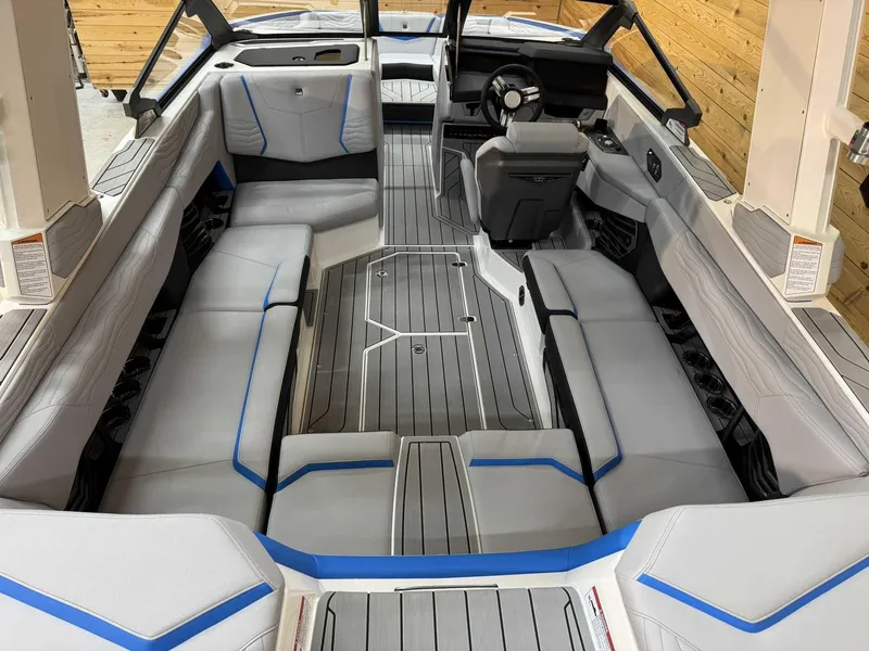 Slide: The Image of 2025 Nautique G23 boat interior with sleek seating and modern dashboard design. - 7