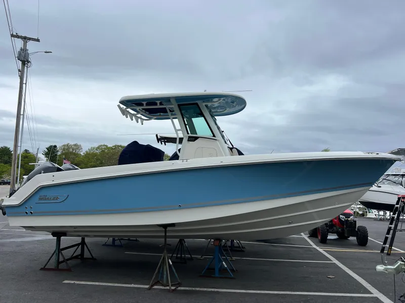 The Image of 2025 Boston Whaler 250 Outrage boat on stands in a parking lot. - 0