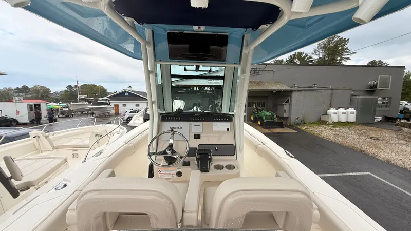 Slide: The Image of 2025 Boston Whaler 250 Outrage boat interior with steering console and seating. - 2