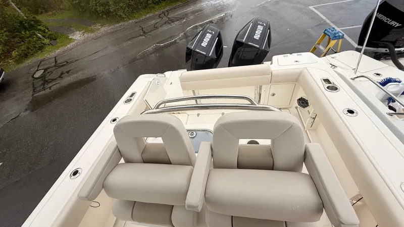 Slide: The Image of 2025 Boston Whaler 250 Outrage boat interior with dual seats and twin outboard engines. - 3