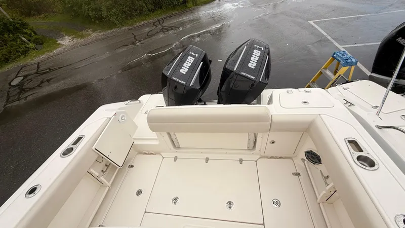 Slide: The Image of 2025 Boston Whaler 250 Outrage boat with dual outboard engines, viewed from the deck. - 5