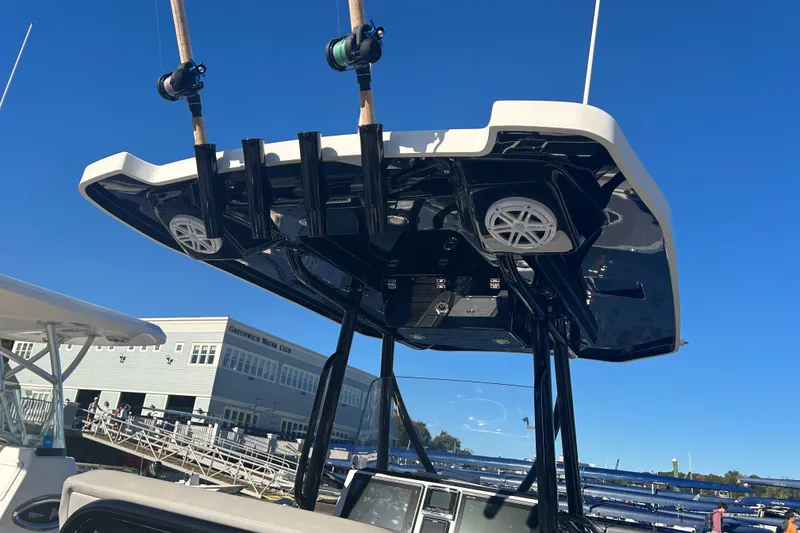 Slide: The Image of 2018 Blackfin 242 CC boat with fishing rods and speakers, docked near Greenwich Yacht Club. - 13