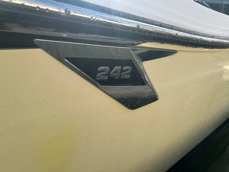 Slide: The Image of 2018 Blackfin 242 CC boat emblem with water droplets on the hull. - 15