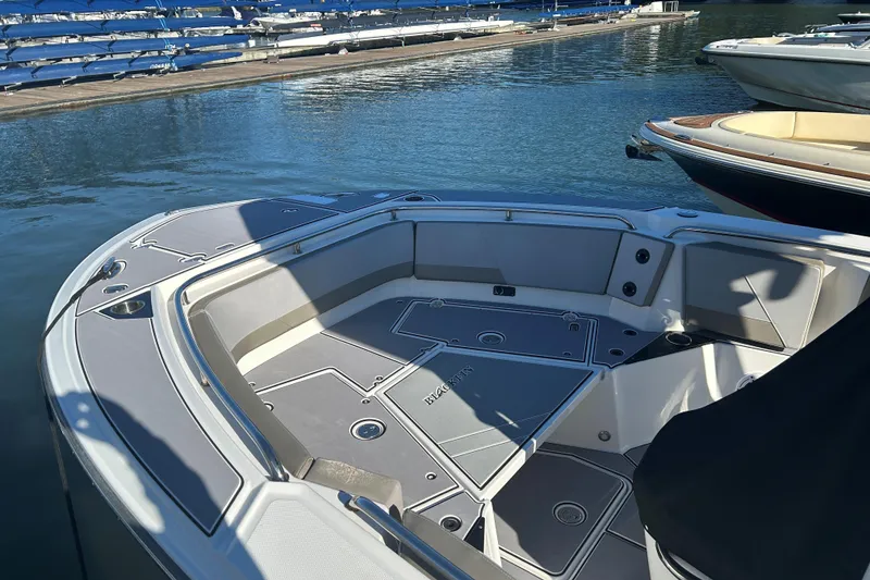 Slide: The Image of 2018 Blackfin 242 CC boat interior at marina, showcasing spacious seating and sleek design. - 8