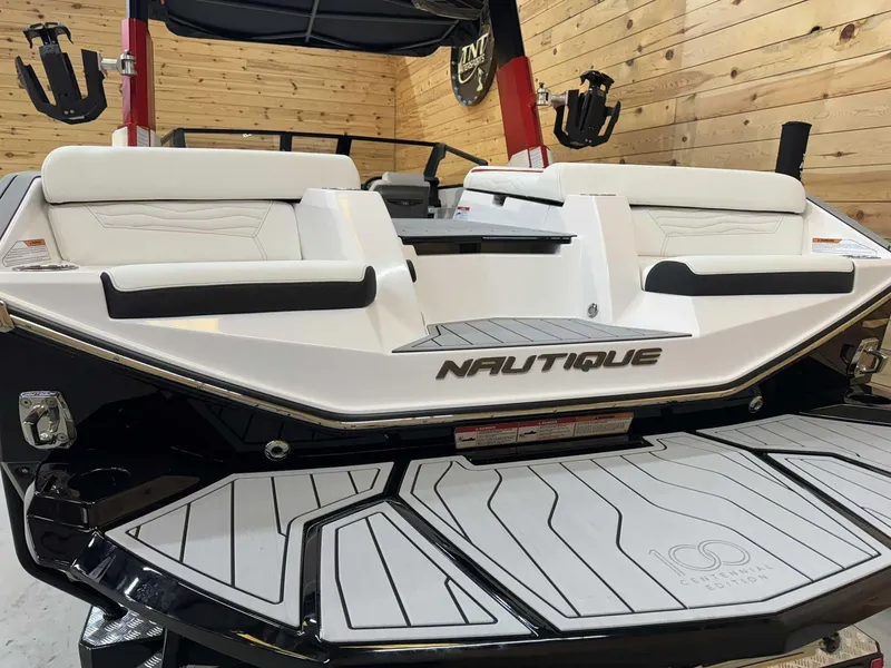 Slide: The Image of 2025 Nautique G23 boat with sleek design and modern seating in a wooden interior setting. - 3