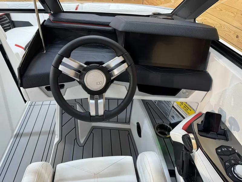 Slide: The Image of 2025 Nautique G23 boat cockpit with modern steering wheel and control panel. - 7