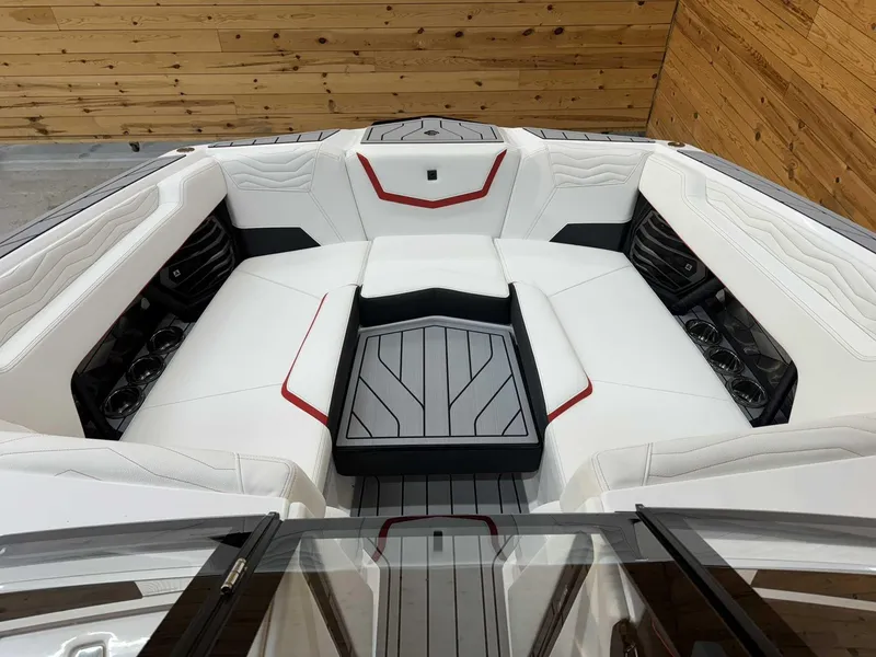 Slide: The Image of 2025 Nautique G23 boat interior with white seating and red accents. - 8