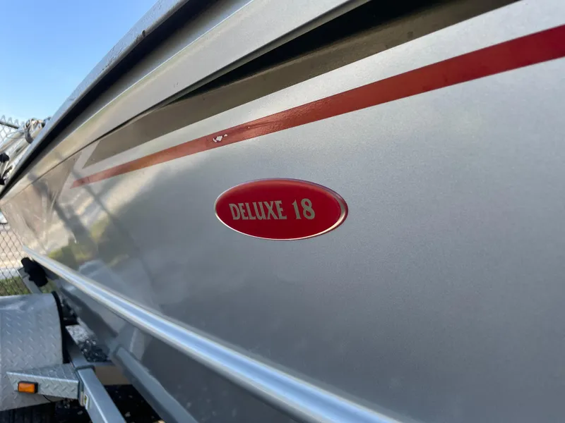 Slide: The Image of 2018 G3 Deluxe 18 boat with red detailing on the side. - 4