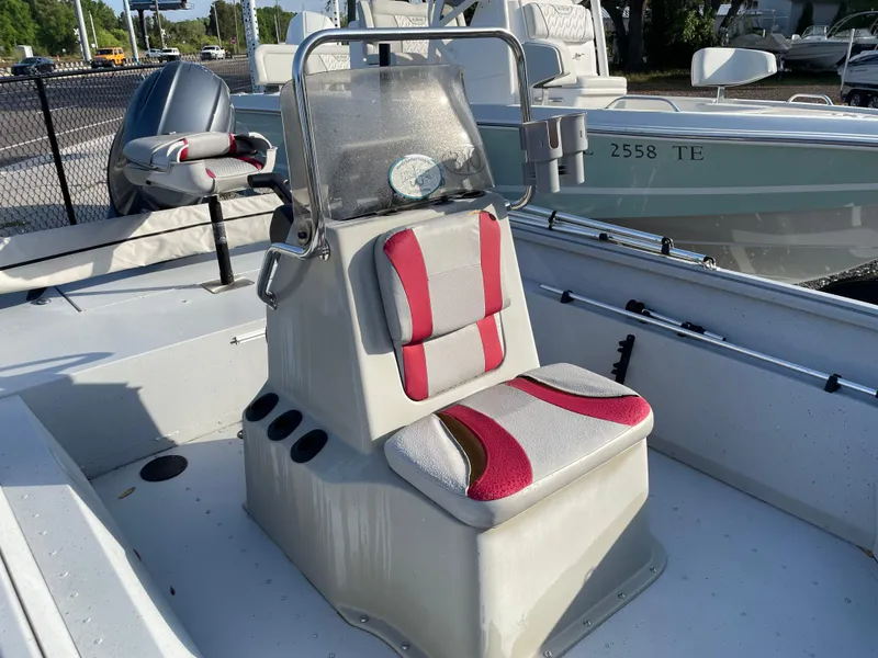 Slide: The Image of 2018 G3 Deluxe 18 boat with red and gray seating, center console, and cup holders. - 6