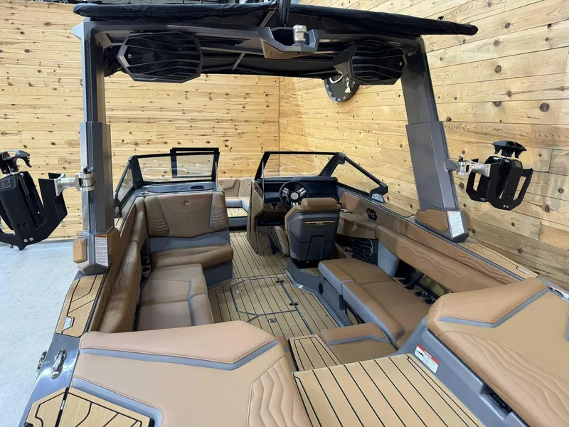 Slide: The Image of 2025 Nautique G23 boat interior with tan seating and modern design. - 14