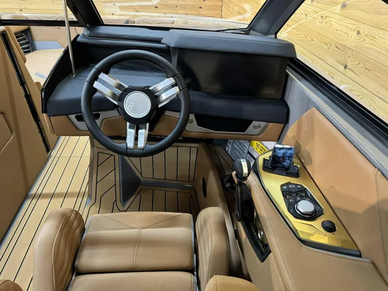 Slide: The Image of 2025 Nautique G23 boat interior with modern steering wheel and control panel. - 9