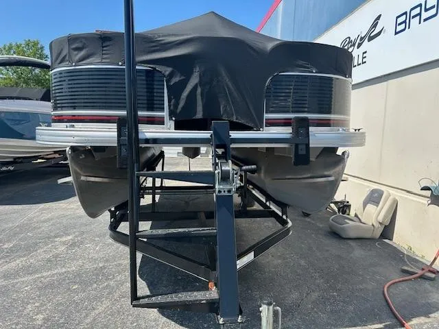 Slide: The Image of 2013 Sun Tracker Fishin' Barge 22 DLX pontoon boat on trailer, covered and parked. - 48