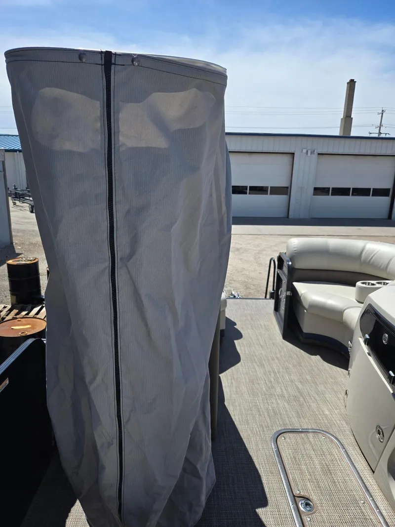 Slide: The Image of 2019 Manitou Oasis VP Tri Toon boat interior with seating and privacy curtain. - 14