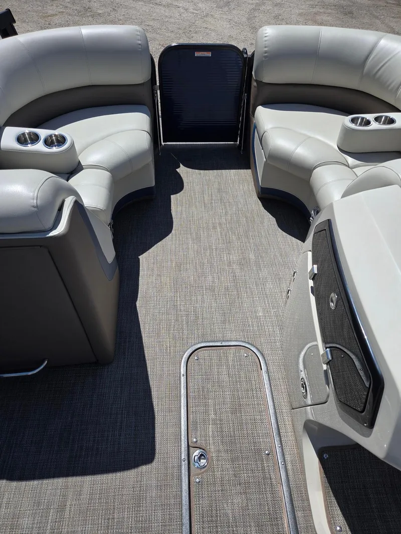 Slide: The Image of 2019 Manitou Oasis VP Tri Toon interior with gray seating and cup holders. - 15