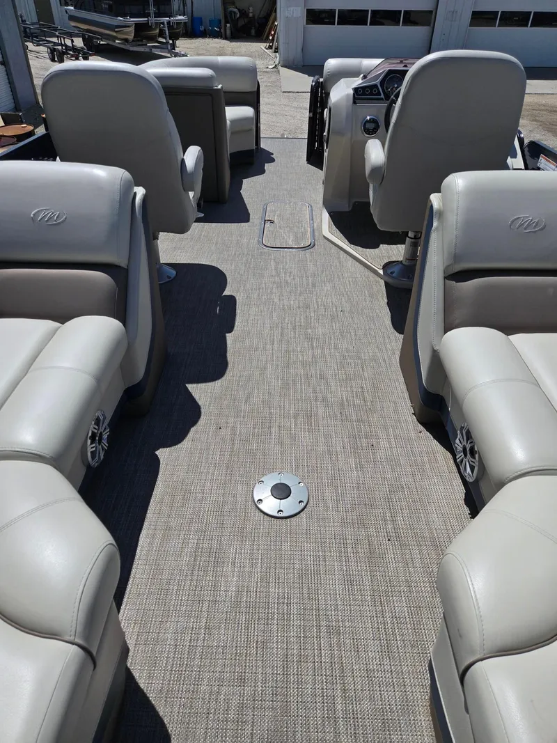 Slide: The Image of 2019 Manitou Oasis VP Tri Toon interior with plush seating and modern dashboard. - 5