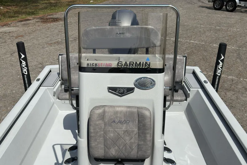 Slide: The Image of 2023 Avid 23 FS boat interior with Garmin equipment and cushioned seating. - 5