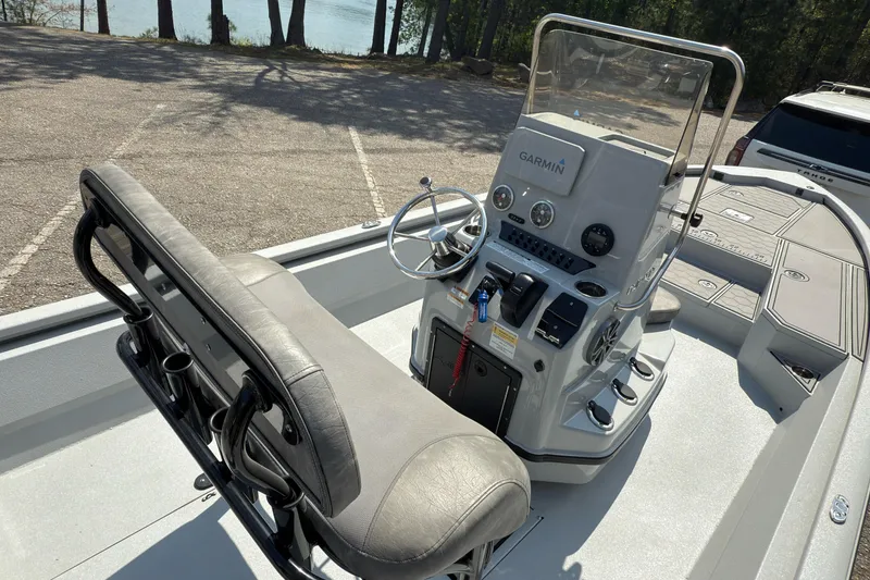 Slide: The Image of 2023 Avid 23 FS boat interior with steering console and seating. - 6