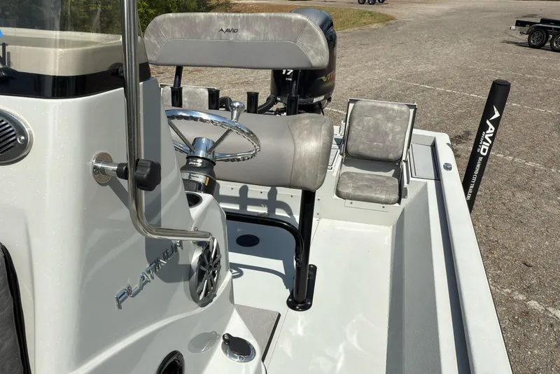 Slide: The Image of 2023 Avid 23 FS boat interior with steering wheel and seating. - 8