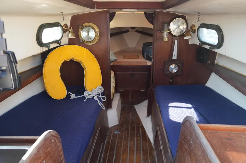 Slide: The Image of Interior of 1982 Cape Dory 25 sailboat with blue cushions and nautical decor. - 4