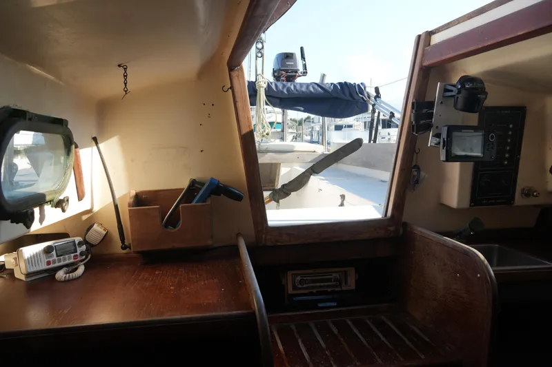 Slide: The Image of Interior of a 1982 Cape Dory 25 sailboat with navigation equipment and wooden finish. - 5
