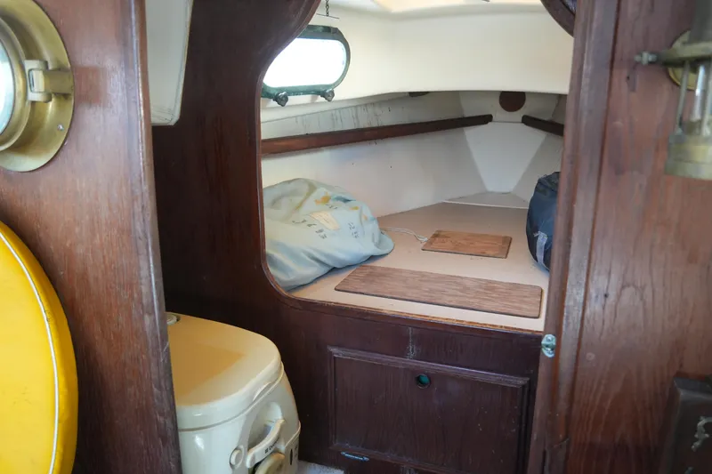 Slide: The Image of Interior of 1982 Cape Dory 25 sailboat with cozy cabin and wooden accents. - 7