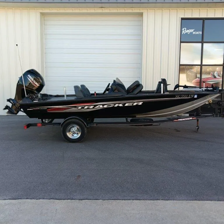 The Image of 2022 Tracker Pro Team 175 TXW boat on trailer, parked outside a building. - 0