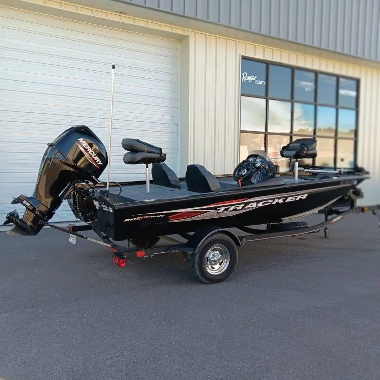 Slide: The Image of 2022 Tracker Pro Team 175 TXW boat parked outside a building. - 2