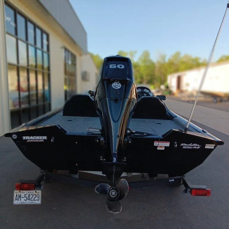 Slide: The Image of 2022 Tracker Pro Team 175 TXW boat with 60 HP engine, parked outdoors. - 4