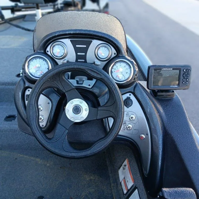 Slide: The Image of 2022 Tracker Pro Team 175 TXW boat dashboard with steering wheel and gauges. - 7