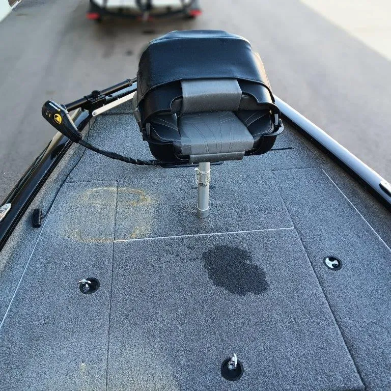 Slide: The Image of 2022 Tracker Pro Team 175 TXW boat deck with a swivel seat and carpeted surface. - 8