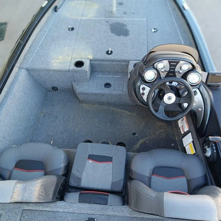Slide: The Image of 2022 Tracker Pro Team 175 TXW boat interior with steering wheel and seating. - 9