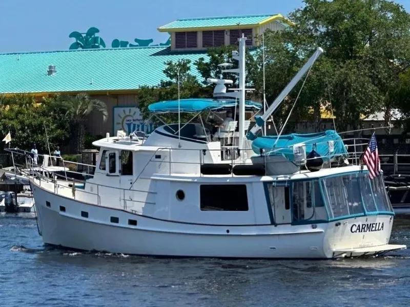 Slide: The Image of Kadey-Krogen 44AE 2019 yacht "Carmella" cruising near a colorful waterfront building. - 10