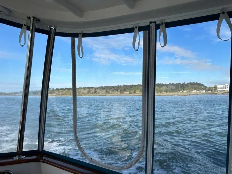 Slide: The Image of View from Kadey-Krogen 44AE boat, 2019 model, overlooking serene waters and distant shoreline. - 11