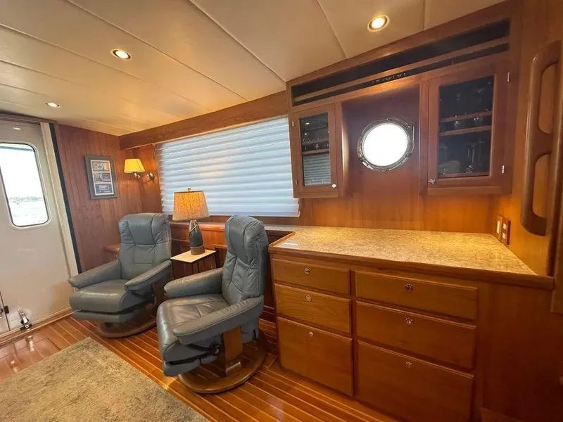 Slide: The Image of Luxurious Kadey-Krogen 44AE 2019 yacht interior with leather chairs and wooden cabinetry. - 14