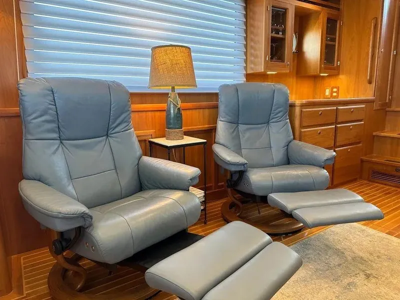 Slide: The Image of Luxurious Kadey-Krogen 44AE 2019 yacht interior with blue recliners and elegant wood finish. - 16