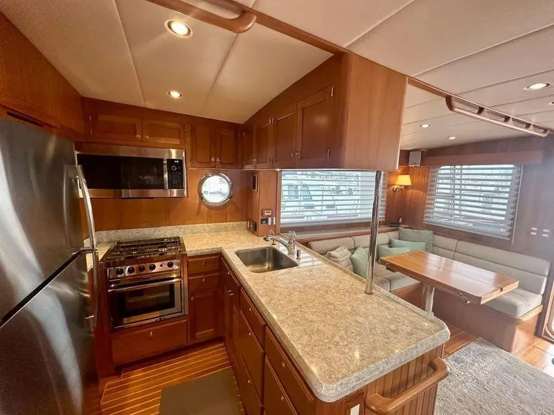 Slide: The Image of Luxurious 2019 Kadey-Krogen 44AE yacht interior with modern kitchen and cozy dining area. - 18