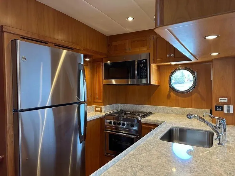 Slide: The Image of Modern kitchen in 2019 Kadey-Krogen 44AE yacht with stainless steel appliances and porthole window. - 19