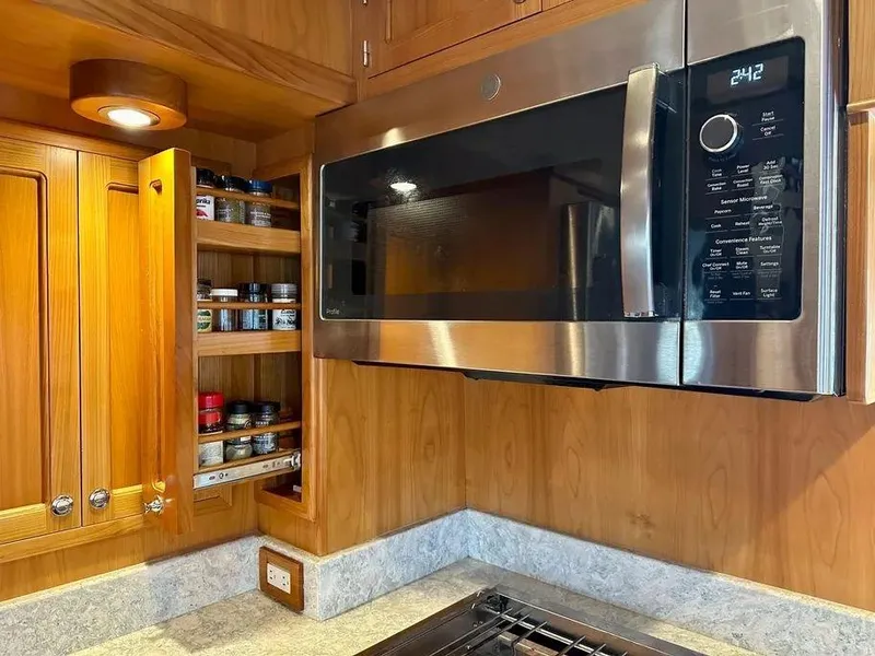 Slide: The Image of Modern Kadey-Krogen 44AE 2019 yacht kitchen with microwave and spice rack. - 22