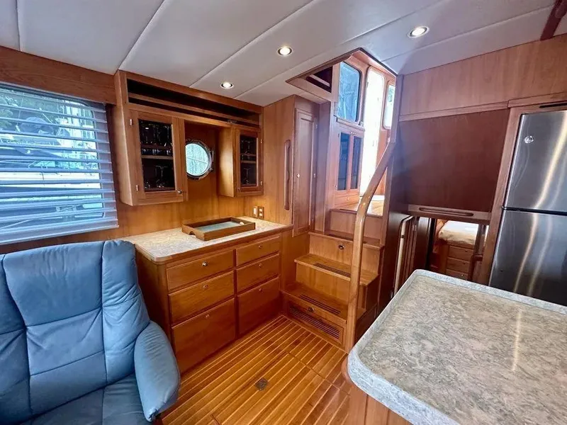 Slide: The Image of Luxurious 2019 Kadey-Krogen 44AE yacht interior with wood cabinetry and modern amenities. - 24