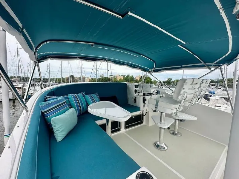 Slide: The Image of Flybridge of 2019 Kadey-Krogen 44AE yacht with blue seating and helm station. - 3