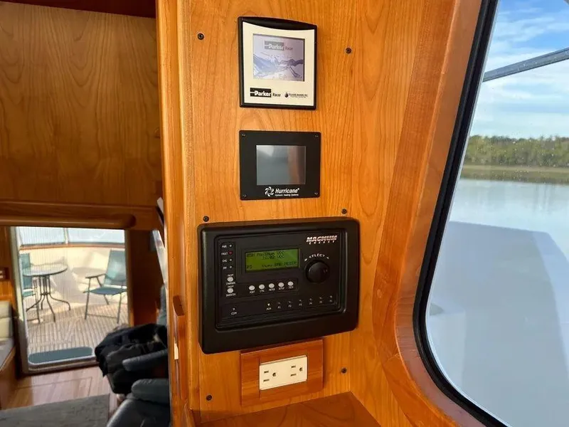 Slide: The Image of Control panel inside 2019 Kadey-Krogen 44AE yacht, featuring navigation and electrical systems. - 30