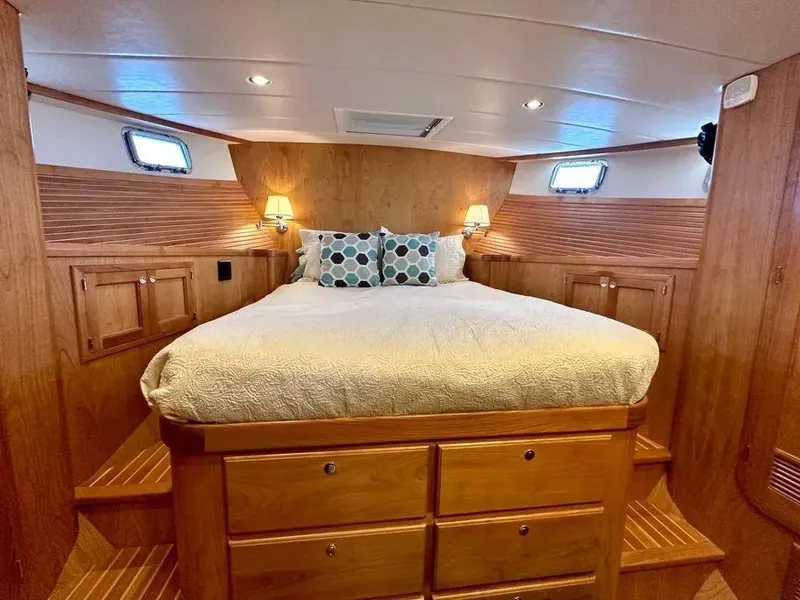 Slide: The Image of Luxurious 2019 Kadey-Krogen 44AE yacht bedroom with cozy bed and wooden cabinetry. - 34