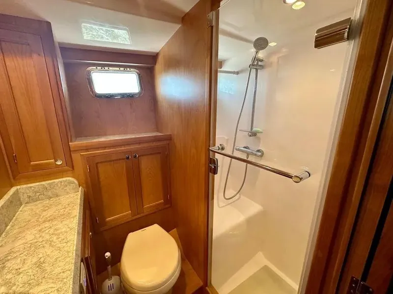 Slide: The Image of Luxurious 2019 Kadey-Krogen 44AE yacht bathroom with wood cabinetry and modern shower. - 36