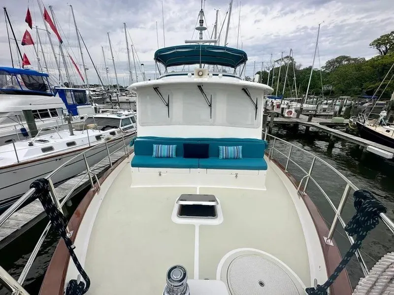 Slide: The Image of Kadey-Krogen 44AE 2019 yacht with blue seating, docked at a marina. - 42