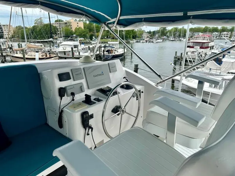 Slide: The Image of Helm of 2019 Kadey-Krogen 44AE yacht with marina view. - 45