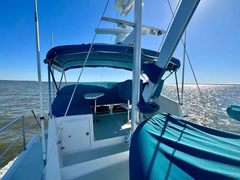 Slide: The Image of 2019 Kadey-Krogen 44AE yacht with blue canopy cruising on open water. - 48