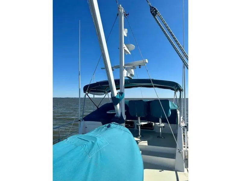 Slide: The Image of 2019 Kadey-Krogen 44AE yacht with blue covers, sailing on open water under clear skies. - 49