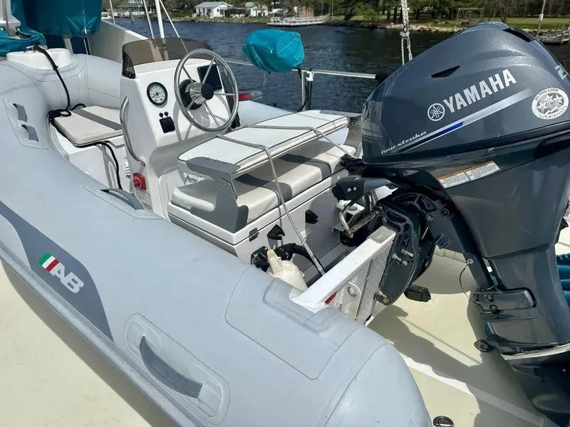 Slide: The Image of Inflatable boat with Yamaha motor on Kadey-Krogen 44AE, 2019 model, docked by a river. - 52