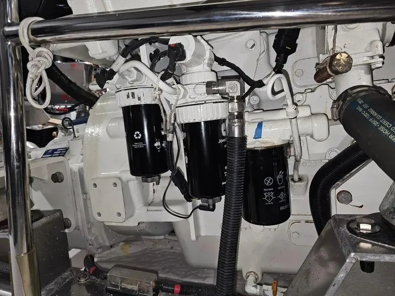 Slide: The Image of Engine components of a 2019 Kadey-Krogen 44AE yacht, featuring filters and hoses. - 63
