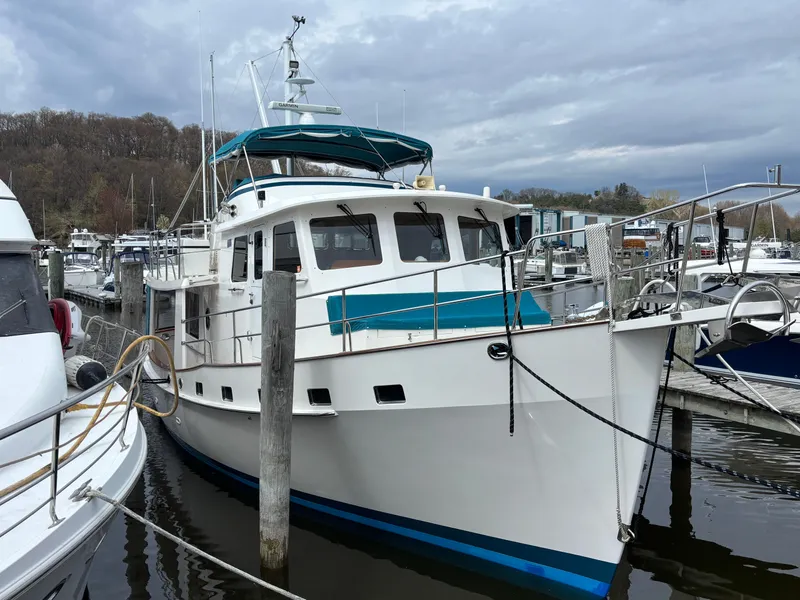 Slide: The Image of 2019 Kadey-Krogen 44AE yacht docked at marina under cloudy sky. - 7
